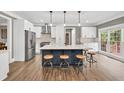 Modern kitchen features a large island, stainless steel appliances, and white cabinetry at 1459 Harris Rd, Lawrenceville, GA 30043