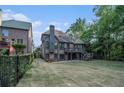 Expansive backyard with well-maintained lawn, mature trees, and an upper deck, perfect for outdoor entertaining at 3574 N Druid Hills Rd, Decatur, GA 30033