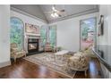 Cozy living room featuring a fireplace, hardwood floors, and abundant natural light at 3574 N Druid Hills Rd, Decatur, GA 30033