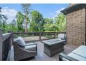 This backyard patio features a fire table, comfortable seating, and serene views of the lush surroundings at 3574 N Druid Hills Rd, Decatur, GA 30033