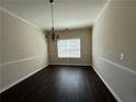Formal dining room with a decorative chandelier and hardwood floors at 4500 Nocohoma Bnd, Douglasville, GA 30135