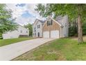 A lovely two-story home with a brick-accented facade and a two-car garage at 4500 Nocohoma Bnd, Douglasville, GA 30135