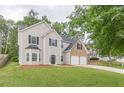 Charming two-story home featuring a two-car garage and a spacious front yard at 4500 Nocohoma Bnd, Douglasville, GA 30135