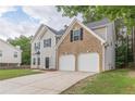 Attractive two-story home with a brick-faced garage and extended driveway at 4500 Nocohoma Bnd, Douglasville, GA 30135