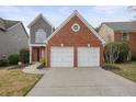 Charming exterior view showcasing a two-story house with a two-car garage and well-kept landscaping at 1265 Birchwood Ln, Roswell, GA 30076