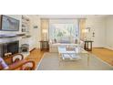 Bright living room features hardwood floors, a fireplace, built-in shelves, and a large window at 2530 Parkdale Pl, Atlanta, GA 30305