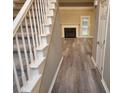 Inviting entryway featuring new luxury vinyl plank flooring, staircase and a view of the fireplace at 263 Northwind Dr, Stockbridge, GA 30281