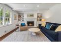 Cozy living room with a fireplace, built-in bookshelves, and comfortable seating, perfect for relaxing and entertaining at 3380 E Wood Valley Rd, Atlanta, GA 30327