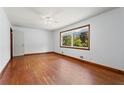 Spacious bedroom with hardwood floors, a ceiling fan, and a large window at 2307 Woodridge Dr, Marietta, GA 30066