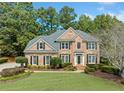 Charming brick two-story home with a well-maintained lawn and mature landscaping for great curb appeal at 374 Meadowmeade Cv, Lawrenceville, GA 30043