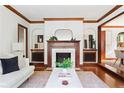 Elegant living room with a fireplace, hardwood floors, and stylish decor at 479 Shannon Sw Dr, Atlanta, GA 30310