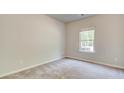 Cozy bedroom with neutral paint, carpet flooring and a bright window view at 119 Felicity Pike, Locust Grove, GA 30248