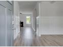 Bright entryway boasts hardwood floors and wainscoting, leading to a living area with a fireplace at 119 Felicity Pike, Locust Grove, GA 30248