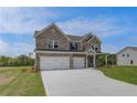 Elegant two-story brick home with a three-car garage and well-maintained landscaping at 119 Felicity Pike, Locust Grove, GA 30248