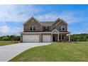 Beautiful two-story brick home featuring a spacious driveway and an attached three-car garage at 119 Felicity Pike, Locust Grove, GA 30248