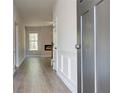 Long hallway showcasing durable floors and leading to living area with fireplace at 119 Felicity Pike, Locust Grove, GA 30248