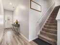 Bright entryway with stylish wood floors, a staircase, and a decorative table, perfect for welcoming guests at 1868 Fabian Way, Austell, GA 30106