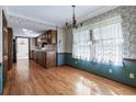 Traditional dining room with hardwood floors and floral wallpaper adjacent to the kitchen at 2340 Castleridge Ct, Tucker, GA 30084