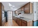 Spacious kitchen with granite countertops, wood cabinets, stainless steel appliances and hardwood flooring at 2340 Castleridge Ct, Tucker, GA 30084