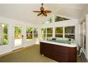 Relaxing sunroom features a hot tub, surrounded by large windows and natural light at 3239 Rose Petal Ln, Powder Springs, GA 30127