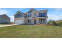Charming two-story home featuring brick and gray siding, a lush green lawn, and a double garage at 123 Felicity Pike, Locust Grove, GA 30248