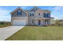Beautiful two-story home with brick and gray siding, a well-kept lawn, and a welcoming front porch at 123 Felicity Pike, Locust Grove, GA 30248