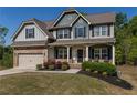 Stunning two-story home with a covered front porch, manicured lawn, and an attached garage, perfect for Gathering living at 19 Four Feathers Ne Ln, Rydal, GA 30171