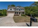 Gorgeous two-story home features an attached garage, inviting front porch, and well-kept lawn with fresh landscaping at 19 Four Feathers Ne Ln, Rydal, GA 30171