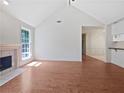 Bright open-concept living room with high ceilings and wood floors, fireplace at 1704 Golf Link Dr, Stone Mountain, GA 30088