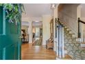 Welcoming foyer with hardwood floors, staircase with decorative spindles, and views into the living spaces at 5251 Amberbrook Ct, Marietta, GA 30068