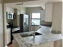 Modern kitchen featuring stainless steel appliances, granite countertops, and a stylish faucet at 795 Hammond Dr # 1908, Atlanta, GA 30328