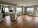 Bright living room with hardwood floors, large windows, and an open kitchen concept at 795 Hammond Dr # 1908, Atlanta, GA 30328