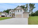Stylish new brick home featuring a spacious three-car garage, and neatly maintained lawn at 174 Haverling Pass, Hampton, GA 30252