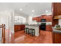 Inviting kitchen boasts dark wood cabinets, modern appliances, and a central island with seating, perfect for cooking and entertaining at 282 Autry Mill Ln, Suwanee, GA 30024