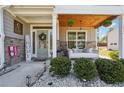 Inviting front porch with a porch swing, stone accents, and decorative welcome sign at 2860 Windsor Knoll Dr, Dacula, GA 30019