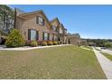Lovely two-story brick home with shutters, landscaping and a sidewalk at 3798 Spring Place Ct, Loganville, GA 30052