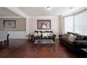 Comfortable living room featuring hardwood floors, neutral paint, and plenty of natural light at 3798 Spring Place Ct, Loganville, GA 30052