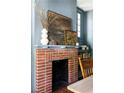 Close-up of the dining room fireplace with beautiful brickwork and decorative mantle at 836 Dill Sw Ave, Atlanta, GA 30310