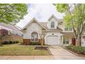 Charming home featuring a one-car garage, lovely landscaping, and large arched window offering natural light at 1052 Pike Forest Ct, Lawrenceville, GA 30045