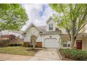Attractive home boasts a one-car garage and a well-manicured lawn, with ample curb appeal at 1052 Pike Forest Ct, Lawrenceville, GA 30045