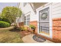 Inviting front entryway with a decorative wreath on the door and a cozy seating arrangement at 1052 Pike Forest Ct, Lawrenceville, GA 30045