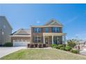 Beautiful two-story brick home with a well-maintained lawn and attached two-car garage at 1060 Crescent Ridge Dr, Buford, GA 30518