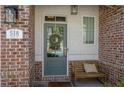 Inviting front porch with a cozy bench and decorative wreath, showcasing the charming entrance of the home at 518 Coral St, Marietta, GA 30064