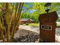 Inviting brick home with a well-maintained lawn and an address marker on the front entrance at 215 The Farm Rd, Mcdonough, GA 30252