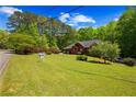 Lovely home showcasing a spacious front yard and lush landscaping at 215 The Farm Rd, Mcdonough, GA 30252