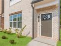 Inviting front entrance with a modern door, house number, and landscaped lawn at 3409 Catalan Aly, Decatur, GA 30032