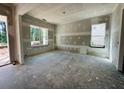Bright, unfinished living room boasts abundant natural light with open doorway to the outdoor space at 3375 Hillshire Dr, Cumming, GA 30028