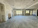 Expansive living room showing incomplete drywall, large windows, and versatile layout at 3375 Hillshire Dr, Cumming, GA 30028