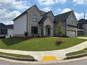 A beautiful two-story home with light gray siding and a well-manicured front yard at 4201 Hosch Reserve Dr, Buford, GA 30519