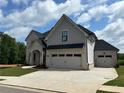 New two-story home featuring a two-car garage, concrete driveway, and manicured lawn at 4201 Hosch Reserve Dr, Buford, GA 30519